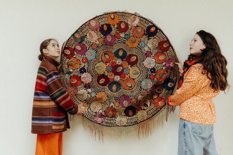 lovely piece of embroidered textile, mounted on an iron circle...