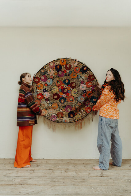 lovely piece of embroidered textile, mounted on an iron circle...